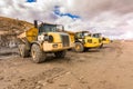 Large trucks in an open pit mine