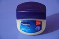 A large tub of Vaseline petroleum jelly isolated blue background. : A jar of Petroleum jelly which is used as over the counter