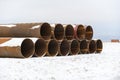 Large tubes in winter tundra. Construction Marine offshore works. Dam building