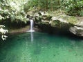 A large turquoise basin in the forest