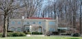 Stucco Mansion with Red Tile Roof in Wooded Setting Royalty Free Stock Photo