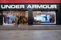 Large UNDER ARMOUR store and Chinese customers in face mask