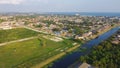 Large vacant land near Farrar Canal with residential houses, duplex townhomes, lush green trees in Little Woods neighborhood Royalty Free Stock Photo