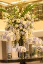 Large vases with many types of white and purple flowers decorate the hotel lobby