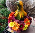 Large vegetable surrounded with flowers and fern to resemble a person