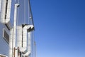 Large ventilation ducts outside industrial knowledge and thermal insulation against a blue sky Royalty Free Stock Photo