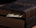 Large vintage book with dollar cash note used as