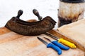 Large vintage three blade mezzaluna with three knives on cutting board. Ready for pig processing