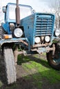 A large, vintage tractor, blue color is on the farm. Royalty Free Stock Photo