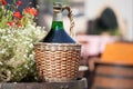 Large Vintage Wine Bottles in wicker basket on a barrel Royalty Free Stock Photo