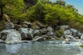 Large volcanic boulders line the river bank of the Alcantara river near Taormina, Sicily