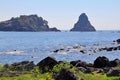 Large volcanic rocks on the seashore, by the beach, volcanic islets away from the beach, the Ionian Sea and volcanic uplift Royalty Free Stock Photo