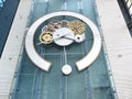 A large wall clock hangs at the entrance to the mall