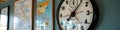 Large wall clock with time zone map and charts in office setting Royalty Free Stock Photo