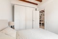 Large wardrobe and soft bed in white minimalist bedroom Royalty Free Stock Photo