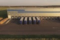 Large warehouse complex with parked trucks awaiting loading. Logistics center, warehouse terminal Royalty Free Stock Photo