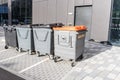 Large waste and recycling bins at the back of a office building