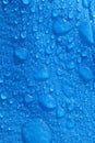 Large water droplets on blue polyethylene blue tarpaulin in daylight Vertical Royalty Free Stock Photo