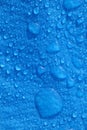 Large water droplets on blue polyethylene blue tarpaulin in daylight Vertical Royalty Free Stock Photo