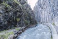 Large water-filled channel between mountain walls on the route of the Monachil river, in Los Cahorros, Granada