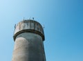 Large, concrete water tower with telecom and wireless 4G antennas. Royalty Free Stock Photo