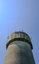 Large, concrete water tower with telecom and wireless 4G antennas. Royalty Free Stock Photo