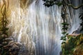 A large waterfall in a cave in the tropical mysterious fairy jungle.