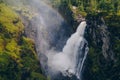 Large waterfall falling into a deep ravine in the woods