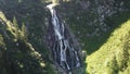 The large waterfall flowing from the mountain. Waterfall with a very high flow. Waterfall Balea.