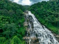 Large waterfall with lush green forest in the background. Nature landscape. Water is crystal clear and trees are full and green. Royalty Free Stock Photo