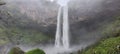 Large waterfall on a rainy day with vegetation Royalty Free Stock Photo