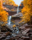 Large waterfall surrounded by vibrant fall foliage color. Kaaterskill Falls, Woodstock NY