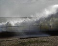 Large wave crashing over rails