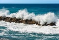 Large Waves of the Sea Break on the Rocks - Breakwater in Liguria Italy Royalty Free Stock Photo