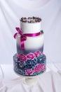 Wedding cake ornamented in rustic style blue and purple roses