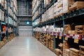 Large wharehouse with rows of shelves and goods boxes Royalty Free Stock Photo