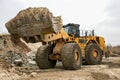 Large wheel loader with raised bucket.