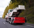 Large wheeled mobile portable crane with extendable boom on road Royalty Free Stock Photo