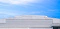 Large white aluminium industrial factory building with dome roof in modern style against blue sky background in panoramic view Royalty Free Stock Photo