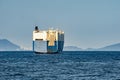 Large White and blue Roll-on/roll-off RORO or ro-ro ships or oceangoing vehicle carrier ship anchor in the open sea. Roro ship