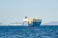 Large White and blue Roll-on/roll-off RORO or ro-ro ships or oceangoing vehicle carrier ship anchor in the open sea. Roro ship