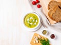 Large white bowl with vegetable green cream soup of broccoli, zucchini, green peas on white background, top view, copy space Royalty Free Stock Photo