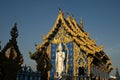 A large white Buddha image in the forbidding posture at The back of the beauty blue chapel of Wat Rong Suea Ten temple