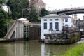 Large buildings and steps leading down to water, where Locks are raised and lowered for boats passing through, Lockport, New York,