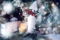 Large white candle in a wicker holder under a Christmas tree. Christmas holiday design. decorated with garlands and Royalty Free Stock Photo