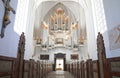 Large white church organ in an empty church