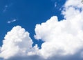 Large white clouds on a background of blue sunny summer sky. Blue sky in the left corner