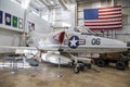 A large white fighter jet surrounded by flags at USS Alabama Battleship Memorial Park in Mobile Alabama