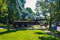 A large white heavy duty truck with a crane is seen with its front elevated wheels off of the ground by stabilizers Royalty Free Stock Photo