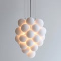 A large white light fixture with many balls hanging from it, AI